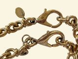 a close up of a gold bracelet with a clasp