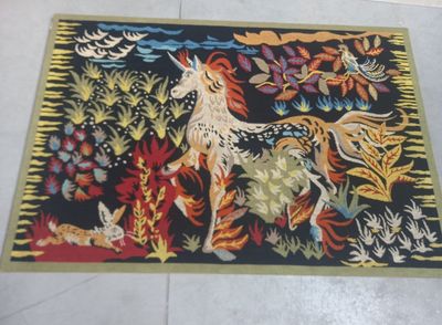 a rug with a picture of a unicorn and other animals on it