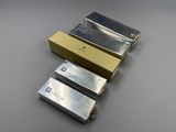 three pieces of metal are sitting next to each other on a table