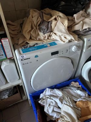 a washer and a dryer in a room with a tiled floor
