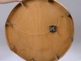 a person that is holding a wooden clock in their hand