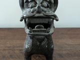 a small statue of a dragon on a wooden table