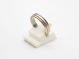 a close up of a silver and gold ring on a white surface
