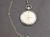a silver pocket watch with a chain attached to it