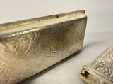 a silver purse sitting next to a small silver box