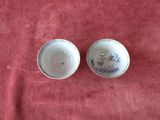pair of blue and white porcelain bowls on a red cloth