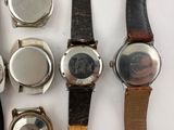 a lot of watches that are sitting on a table