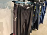 clothing hanging on a rack in a clothing store next to other clothing