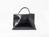 a black leather handbag on a white background