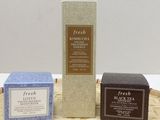 three different types of soaps sitting on top of a bamboo mat