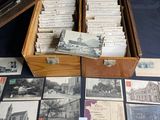 a box full of old postcards on a table