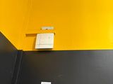 yellow and black painted walls in a bathroom with a toilet and sink