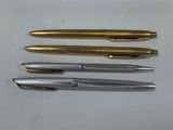 three different types of pens are lined up on a white surface