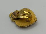 gold plated brooch with a shell and shell shell on it
