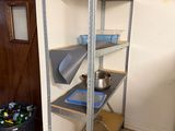 a kitchen with a stove, refrigerator, and shelves in it