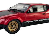 red and black model of a sports car on a white background