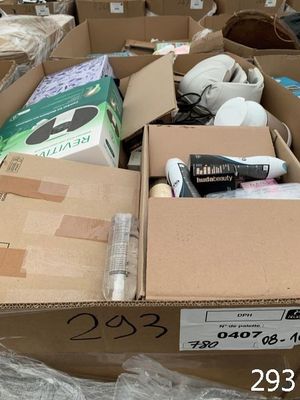 a cardboard box full of items that are sitting on the ground