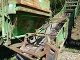une grosse machine verte qui est garée dans l'herbe