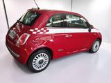 a small red car that is parked in a garage