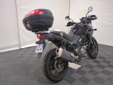 a motorcycle that is parked in a room with a checkered floor