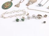 many different types of necklaces and charms on the table