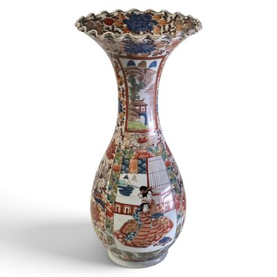 a vase that has a picture of people on it