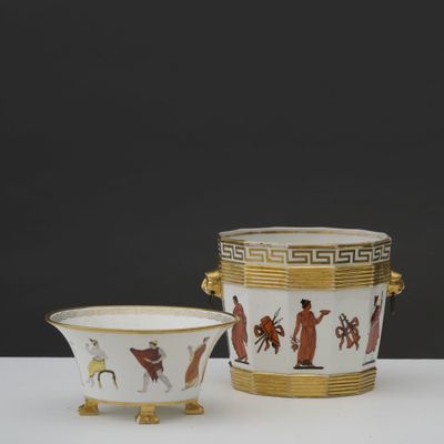 two vases and a bowl on a table with a black background