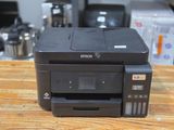a close up of a printer sitting on top of a wooden table