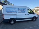 the white van is parked in front of the building