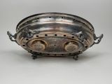 an antique silverplated bowl with handles and handles on a white surface