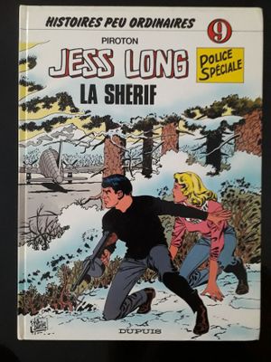 On y voit la couverture de la bande dessinée « Les Long, le shérif ».