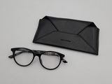 a pair of glasses and a black case on a table