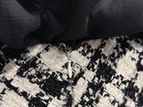 a black and white rug with a pair of scissors on top of it