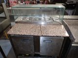 a counter that has a glass case on top of it