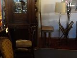 two chairs and a grandfather clock in the corner of a room