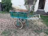 a green wagon with a wooden box in it