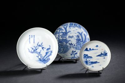 three blue and white plates with designs on them sitting on a table