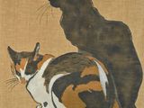two cats that are sitting next to each other