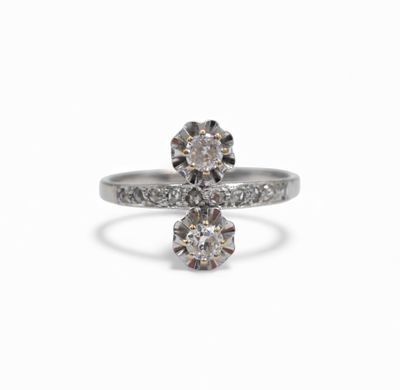 a close up of a diamond ring on a white background