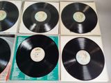 four black vinyl records sitting on top of each other on a table