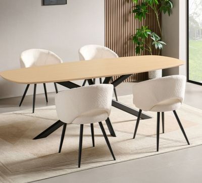 a table with chairs and a rug in a room
