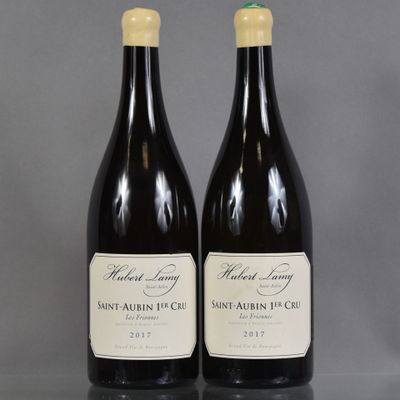 two bottles of wine sitting on top of a table next to each other
