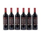 four bottles of red wine are lined up on a white surface