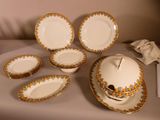 a lot of plates and bowls that are on a table