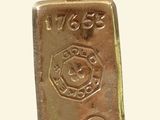 an image of a gold bar pendant with a fire department emblem on it