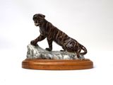 statue of a tiger on a rock on a white background
