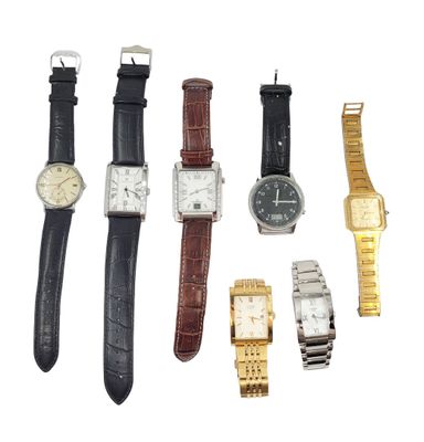 several different types of watches are arranged in a row on a white surface