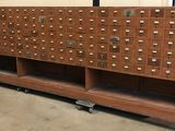 a large wooden cabinet with many drawers on it