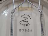 a close up of a white plate with a sign on it