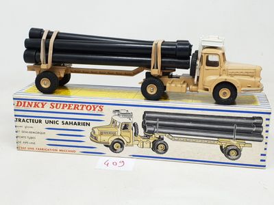 a toy truck with a large pipe attached to it ' s back